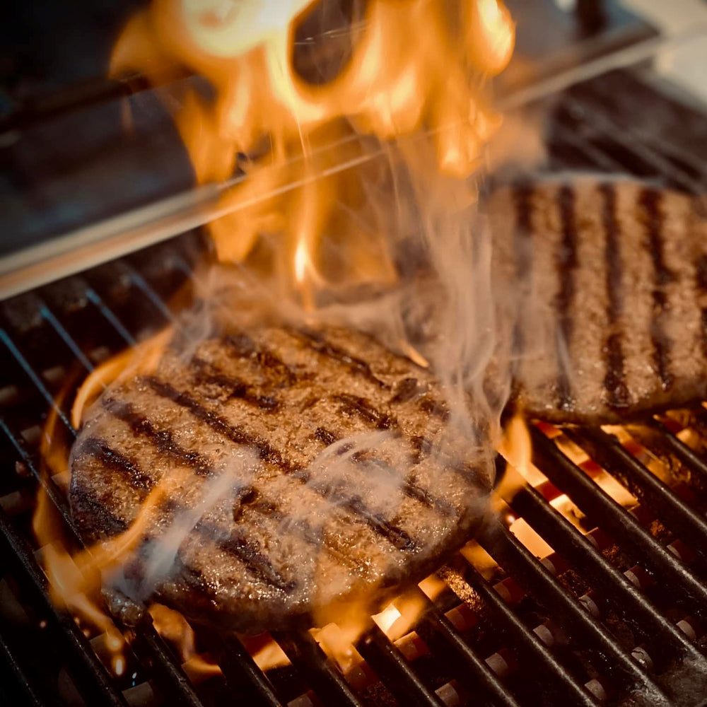 Wagyu Burger, saftige Patties auf dem Grill, in der Flamme gegrillt